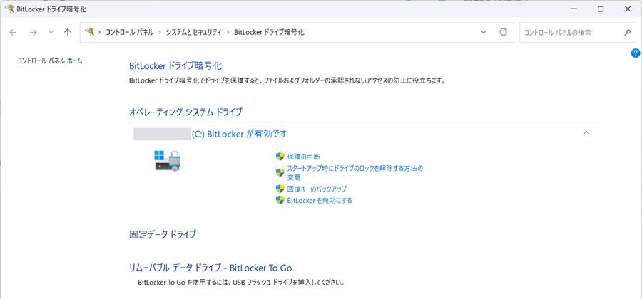 Windowsの「BitLocker ドライブ暗号化」の画面。「オペレーティング システム ドライブ」の（C:）に「BitLocker が有効です」と出ている。右に「保護の中断」「回復キーのバックアップ」「BitLocker を無効にする」が並ぶ